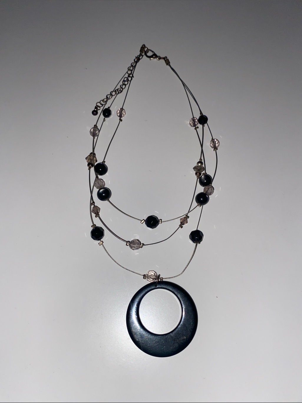 Multi-Strand Black Bead Necklace With Round Pendant
